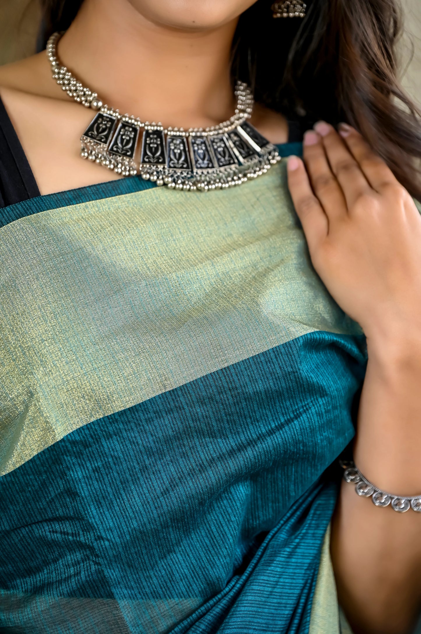 Teal green color kota silk saree with heavy zari border