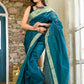 Teal green color kota silk saree with heavy zari border