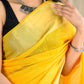 Bright yellow color kota silk saree with heavy zari border